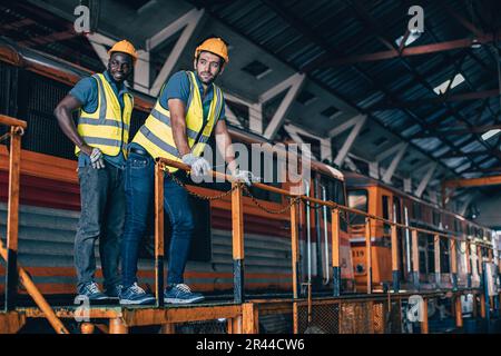 Engineer mechanic team workers standing relax in Diesel Locomotive Repair Shops Stock Photo