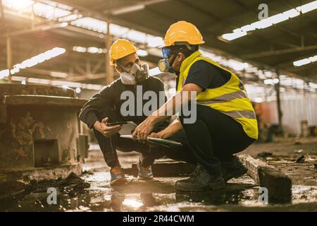 Industry environment impact inspector team work investigate danger chemical oil gas leak with safety face mask Stock Photo