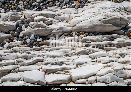 Pebbles and chalk rocks on a beach in Dorset for wall art Stock Photo