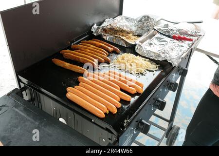 A traditional australian bbq sausage sizzle, sausages cooking on a barbeque Stock Photo