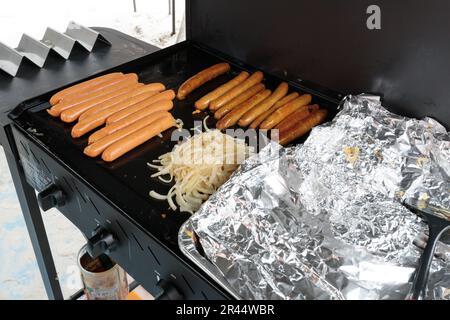 A traditional australian bbq sausage sizzle, sausages cooking on a barbeque Stock Photo