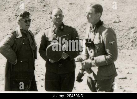 Gunter Alquen (Leibstandarte Adolf Hitler, Greece 1941), an SS photographer, documented Nazi atrocities in Greece during World War II. His lens captured the horror and suffering inflicted upon innocent civilians and resistance fighters.  Images of Sepp Dietrich, accompanied by officers, captured in photographs alongside soldiers, Greek soldiers and civilians, Greek countryside, buildings, pontoon bridge operations. Numerous vehicles bearing tactical symbols, along with the aftermath of destruction: ruined buildings, vehicles, equipment. Artillery shelling and scenes depicting a war-torn countr Stock Photo