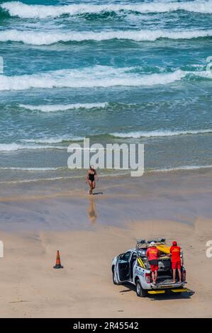 London, UK. 26th May, 2023. Lifeguards watch out for swimmers and surfers - People enjoy sunny wether on the beach as seen from the Tate St Ives. Credit: Guy Bell/Alamy Live News Stock Photo