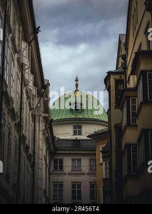 Coupola of the Hofburg seen from the Hofgasse street in Innsbruck Austria Tyrol state, rainy cloud weather moody Stock Photo