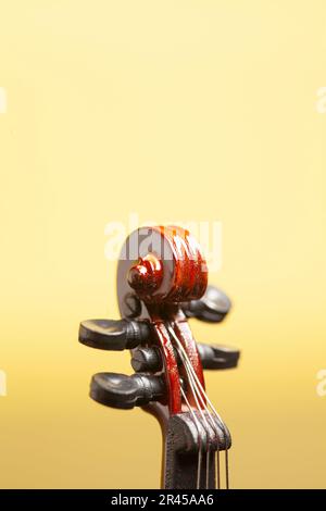 Details with part of violin on a yellow background. Stock Photo