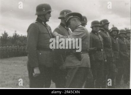 Augustin, Paul, SS photographer of the Leibstandarte Adolf Hitler. Documented events in Holland, France (1940) and Russia (1941-43). French prisoners of war, bridging building, anti-tank gun crew, machine gun team, vehicle convoys on the road and in cities, Belgian forts, prisoner of war camp, scenes of destruction, post-combat and occupation activities, training and sports activities, Hitler Youth and Bund Deutscher Mädel (League of German Girls) sports activities and cultural performances, unit formations and ceremonies, field hospital, individual and group formal photos, light anti-aircraft Stock Photo