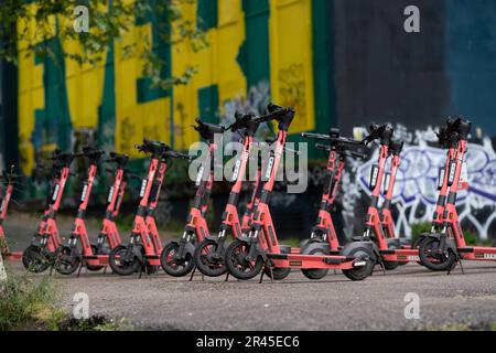 A large number of Voi electric rental scooters parked in the centre of Bristol, England, UK. The electric scooters can be hired via an app. Stock Photo