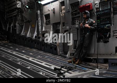 14th Airlift Squadron C-17 Globemaster III loadmaster, Senior Airman Luccas Pantoja, prepares to open the cargo ramp on a C-17 before flying over the Ravenal Bridge during a mass force generation exercise at Joint Base Charleston, South Carolina, Jan. 5, 2023. The 437th Airlift Wing launched 24 C-17s, the largest projection of air power in JB Charleston history. Stock Photo