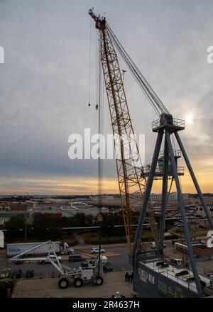 A crane prepares to lift the first-in-class aircraft carrier USS Gerald ...