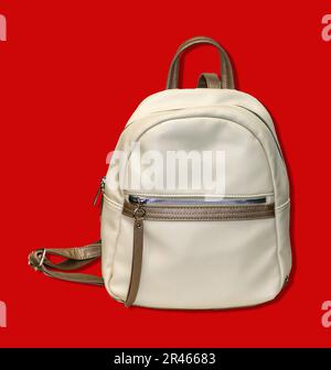 Modern white leather material closed backpack isolated on red background Stock Photo