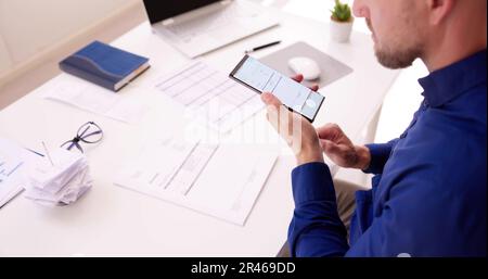 Taking Invoice Document Photo Using Phone Or Smartphone Stock Photo