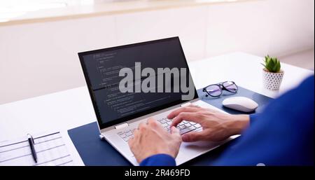 Coder Using Computer At Desk. Web Developer Stock Photo