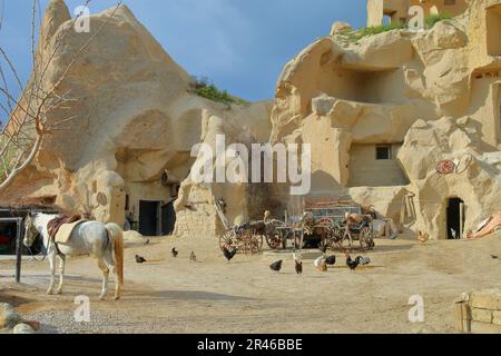 The photo was taken in Turkey, in the area of Cappadocia. The picture shows a nice courtyard of a rural house in the yellow rocks. In the courtyard ar Stock Photo