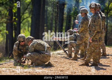 Soldiers from 1st Stryker Brigade Combat Team, 4th Infantry Division aim and shoot a handheld and bipod-stabilized 60mm mortar during the 2023 Best Mortar Competition at Fort Benning, Georgia, on April 11, 2023. Teams were assessed on their ability to quickly employ effective indirect fires on day two of the competition. Stock Photo