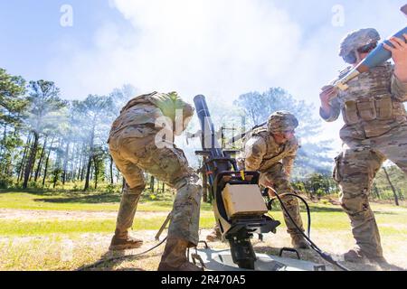The 1st Stryker Brigade Combat Team, 4th Infantry Division team competing in the Best Mortar Competition fires the 120mm mortar on day three of the competition at Fort Benning, Georgia on April 12, 2023. Teams were assessed on the speed in which they could compute a fire mission given target data and make adjustments given corrections from a forward observer, all while impacting a given target beyond the team's line-of-sight. Stock Photo