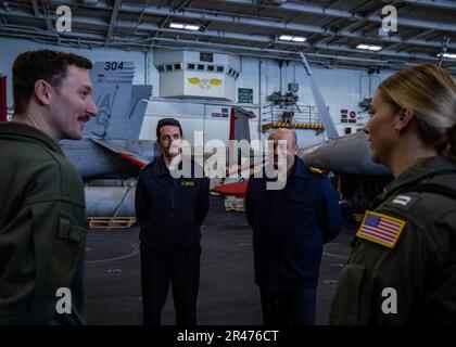 230408-N-SK738-2024 MEDITERRANEAN SEA (April 8, 2023) Lt. Cmdr. Russell Huff, Maintenance Officer, carrier air wing 7, left, gives a tour to Spanish Navy Lt. Carlos Arenas, left center, and Turkish Navy Capt. Guvenc Uysal, distinguished visitors from Standing NATO Maritime Group (SNMG) TWO, aboard the  Nimitz-class aircraft carrier USS George H.W. Bush (CVN 77), April 8, 2023. The George H.W. Bush Carrier Strike Group is on a scheduled deployment in the U.S. Naval Forces Europe area of operations, employed by U.S. Sixth Fleet to defend U.S., allied and partner interests. Stock Photo