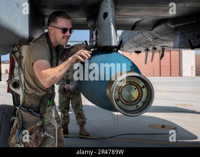 U.S. Air Force Staff Sgt. Andre Kitz, 25th Fighter Generation Squadron weapons load crew member, participates in a weapons load crew of the quarter competition at Osan Air Base, Republic of Korea, March 31, 2023. As part of the competition, teams are evaluated on how quickly and efficiently they are able to inspect and load munitions onto their respective aircraft. Stock Photo