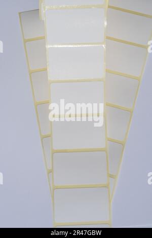 Rolls of white labels isolated. Labels for direct thermal or thermal transfer printing. Blank sticky label roll for thermal transfer printing price cr Stock Photo
