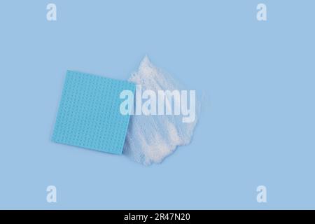 Washing Sponge lying on surface in soapy foam Stock Photo