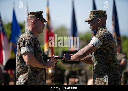 U.S. Marine Corps Sgt. Maj. Oranjel Leavy, right, the outgoing sergeant major of the 15th Marine Expeditionary Unit, passes the sword of office to Col. Sean Dynan, commanding officer of the 15th MEU, during the 15th MEU relief and appointment ceremony at Marine Corps Base Camp Pendleton, California, April 6, 2023. During the ceremony, Leavy relinquished his post to Sgt. Maj. John Schlaud, after serving as the 15th MEU sergeant major since June 2021. Stock Photo