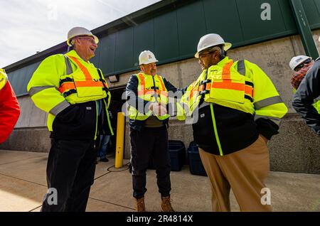 Members of the Society of American Military Engineers greet each other while visiting the construction site at the Monongahela River Locks and Dam 4, operated by the U.S. Army Corps of Engineers Pittsburgh District in Charleroi, Pennsylvania, March 21, 2023.  The U.S. Army Corps of Engineers Pittsburgh District operates the facility and has overseen the construction project at Charleroi to improve inland navigation in the region.  Many of the visitors on the tour represent firms who provided contracts for the project.  The newly constructed chamber is scheduled to fill with water before the su Stock Photo