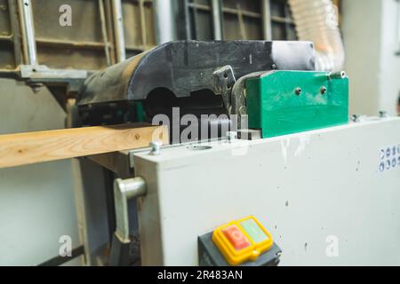closeup shot of a wooden plank in the vacuum system, working on wood concept. High quality photo Stock Photo