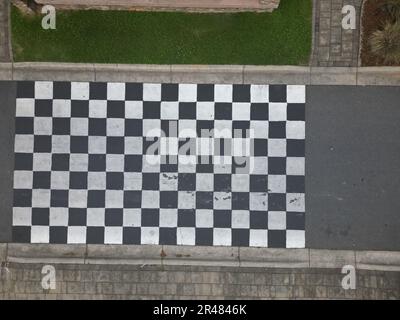 An aerial top view of checkerboard patterns on a raceline Stock Photo