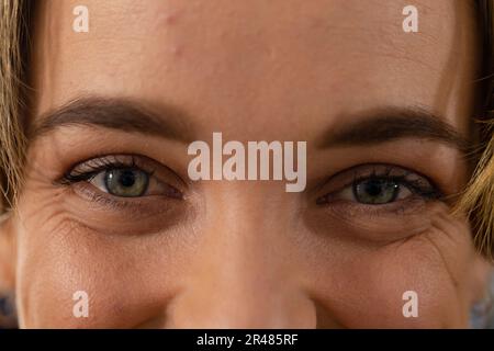 Portrait close up of caucasian female hairdresser with blue eyes smiling Stock Photo