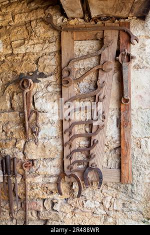 Old set of tools (files, wrenches…) for a blacksmith. Stock Photo