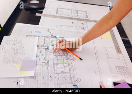 Close up of hand of african american businesswoman drawing architectural plans at office, unaltered Stock Photo
