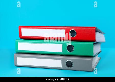 Stack of office folders on light blue background Stock Photo