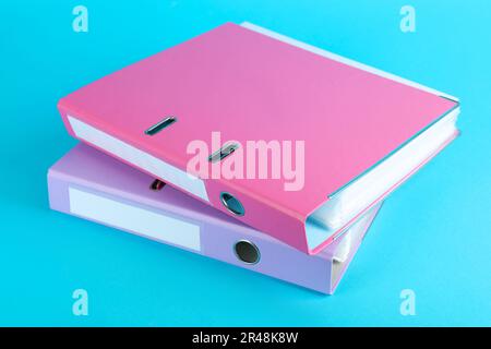 Hardcover office folders on light blue background Stock Photo