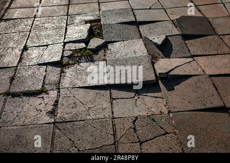 Shattered pavement . Broken cobblestones on the street Stock Photo