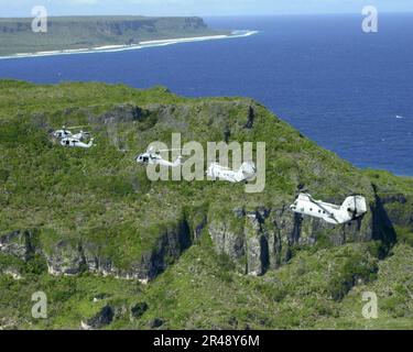 US Navy Two UH-46 ''Sea Knights'' and three UH-60 ''Black Hawks'' fly over the northern tip of Guam as part of a six-helicopter formation during flight training Stock Photo