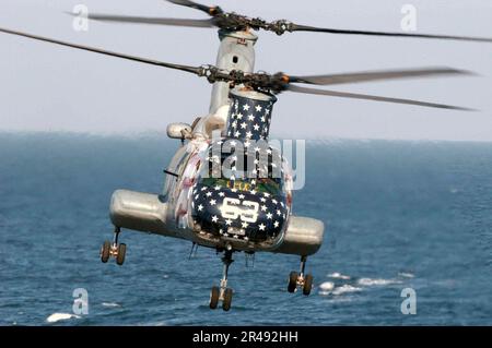 US Navy An CH-46 Sea Knight helicopter assigned to Helicopter Combat Support Squadron Eleven (HC 11) prepares to pick up sling loaded cargo from the fast combat support ship USS Camden (AOE 2) Stock Photo