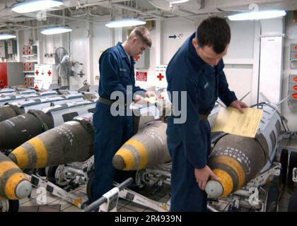 US Navy Aviation Ordnancemen inspect an inert AIM-7 Sparrow air-to-air ...