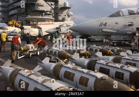 US Navy Aviation Ordnancemen assigned to 'The Swordsmen' of Fighter Squadron Thirty Two (VF-32) Stock Photo