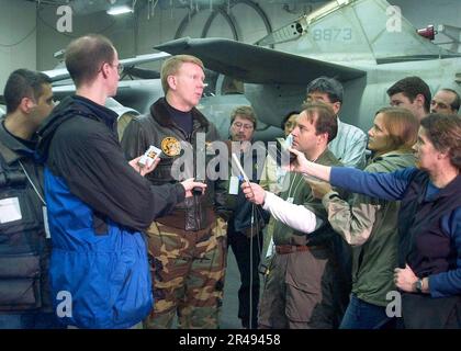US Navy Rear Admiral John D. Stufflebeem, Commander, Carrier Group Two and Commander, Task Force 60, briefs the civilian media in the hangar bay Stock Photo