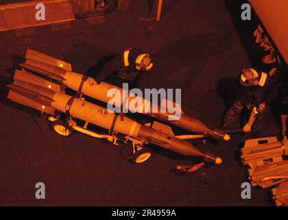 Aviation ordnancemen aboard the aircraft carrier USS Abraham Lincoln ...