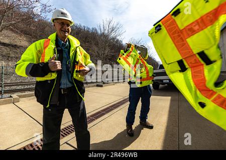 Members of the Society of American Military Engineers put on life jackets while visiting the construction site at the Monongahela River Locks and Dam 4, operated by the U.S. Army Corps of Engineers Pittsburgh District in Charleroi, Pennsylvania, March 21, 2023.  The U.S. Army Corps of Engineers Pittsburgh District operates the facility and has overseen the construction project at Charleroi to improve inland navigation in the region.  Many of the visitors on the tour represent firms who provided contracts for the project.  The newly constructed chamber is scheduled to fill with water before the Stock Photo