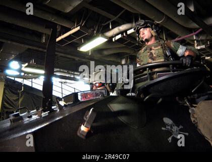 US Navy U.S. Marines assigned to the Second Marine Expeditionary Brigade (2nd MEB) embarked aboard USS Kearsarge (LHD 3) drive a Light Armored Vehicle (LAV) in the ship's well deck to load onto an LCAC from A Stock Photo