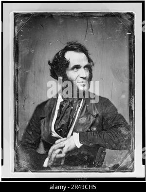 Unidentified man, about 40 years of age, half-length portrait, slightly to left, head three-quarters to right, arm over back of chair, hands clasped in front, with heavy side whiskers, between 1844 and 1860. Stock Photo