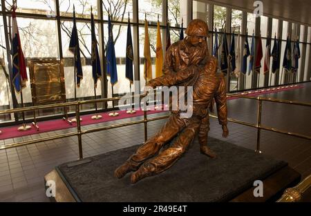 US Navy The bronze statue, depicting the bond between Navy hospital corpsmen and U.S. Marines, stands in the main lobby at the National Naval Medical Center in Bethesda, Maryland Stock Photo