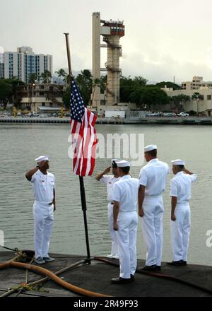 US Navy Hawaii-based Sailors assigned to the attack submarine USS Chicago (SSN 721) observe morning colors at half-mast on Sept. 11, 2003, with a flag sent from the New York City Fire Department Stock Photo