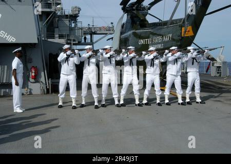 US Navy USS Blue Ridge (LCC 19) ceremonial rifle honor guard fires a 21-gun salute during the ship's Veterans Day commemoration ceremony held aboard the 7th Fleet command ship Stock Photo