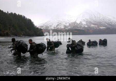 US Navy Navy SEALs perform Advanced Cold Weather training to experience the physical stress of the environment and how their equipment will operate, or even sound, in adverse conditions Stock Photo