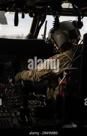 U.S. Army Chief Warrant Officer 2 Amy Hunnewell, a Black Hawk pilot assigned to the 3rd Assault Helicopter Battalion, 1st Aviation Regiment, 1st Combat Aviation Brigade, 1st Infantry Division, performs pre-flight checks at Marshall Airfield on Fort Riley, Kansas March 7, 2023. Soldiers conducted an all-female flight flyover and visited the Amelia Earhart Museum in Atchison, Kansas, to celebrate the achievements of women in aviation. Stock Photo