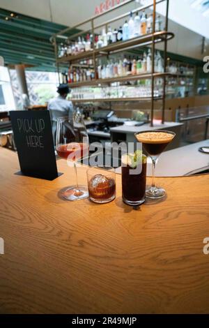 Two beverages with ice cream and Coke served on a wooden bar top Stock Photo