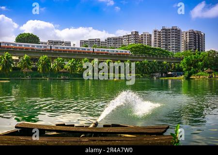 MRT Train passing with The Estuary codo in the background, Yishun Town, Singpore. Stock Photo