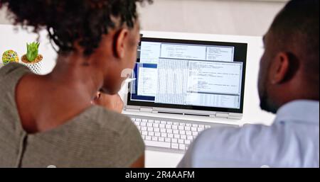 African American Coder Using Computer At Desk. Web Developer Stock Photo